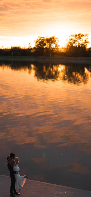 UBC Boathouse - John-MS-Lecky - Just married couple kissing with beautiful orange sunset