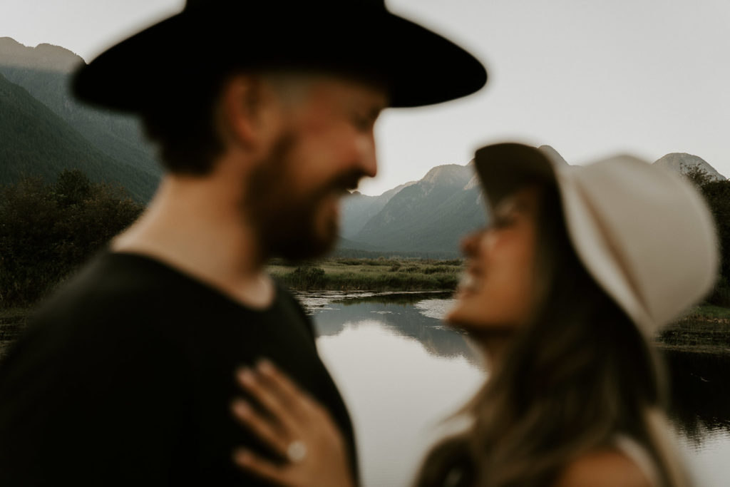 couple with lake reflexion in pitt lake
