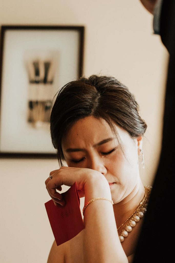 Bride crying when listening benediction from her parents during tea ceremony vancouver