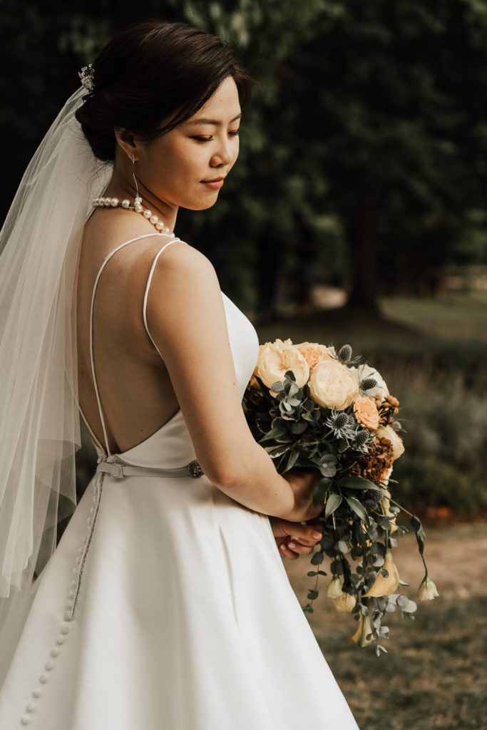 Bride with her bouquet at wedding party session in vancouver park