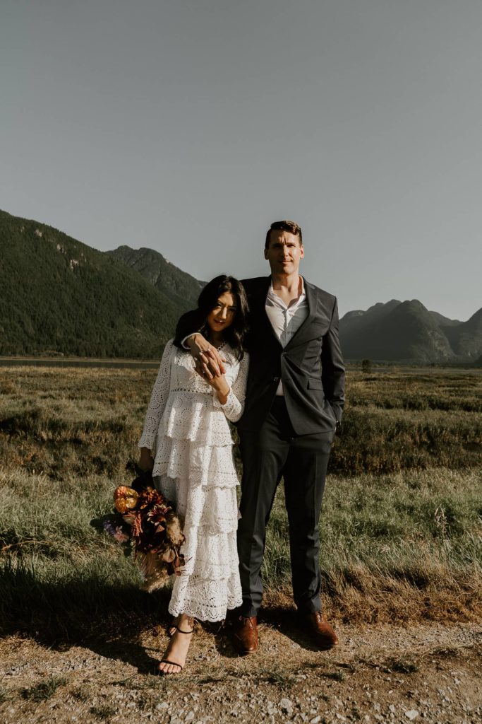 bride and groom serious face with the wedding bouquet