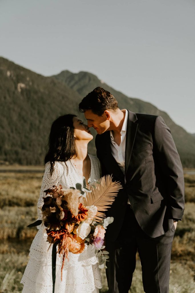 bride and groom slow motion kiss with the wedding bouquet at pitt lake