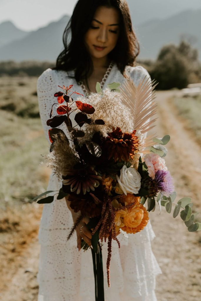 bride holding her wedding bouquet at pitt lake