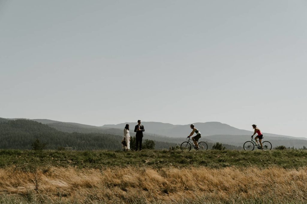 groom and bride waiting with cyclists at pitt lake