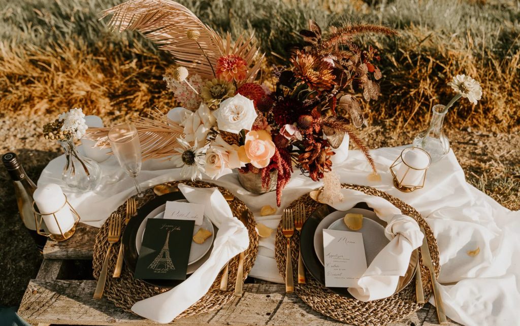 wedding decoration table with flowers stationery gold cutlery and candles