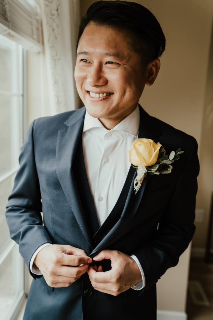 Groom nerar window boutonniere rose