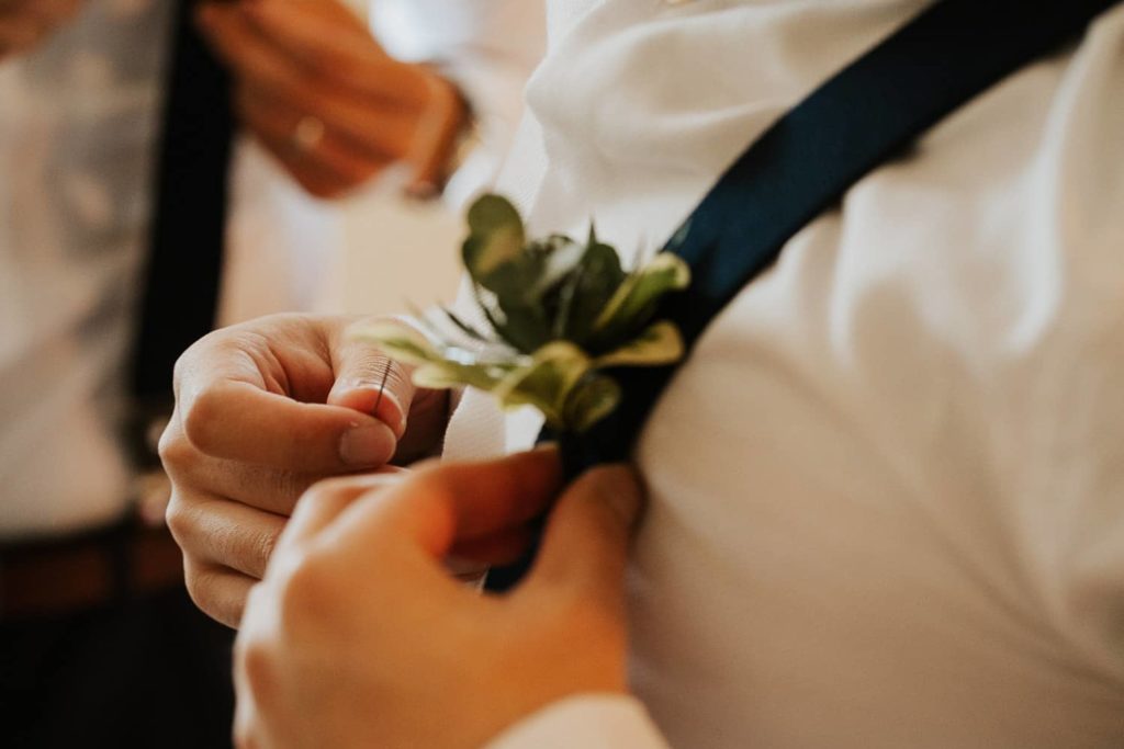 Groomsmen boutonniere on black suspenders