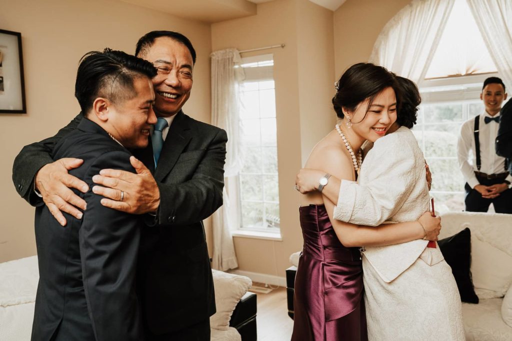 Tea Ceremony hugs laughs parents with couple