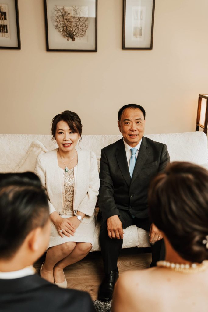bride receiving jewerly from her mom tea ceremony