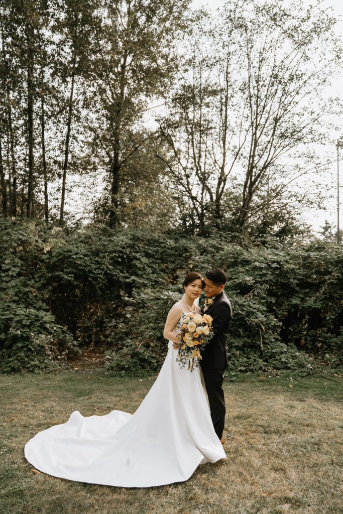 Wedding party picture at surrey bride and groom kissing